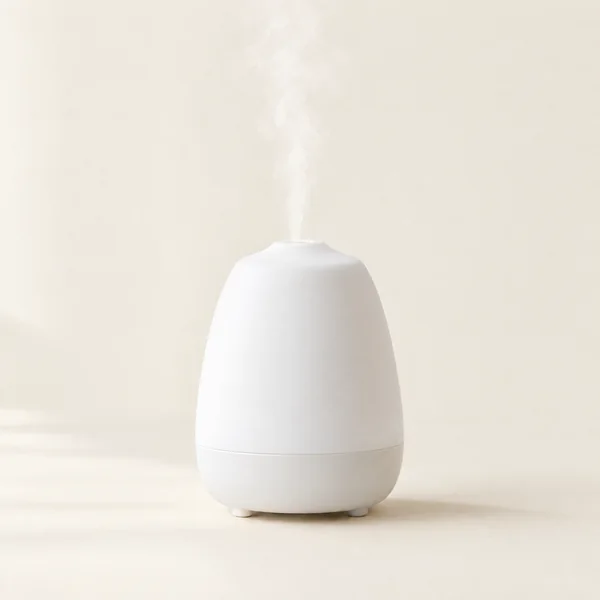 A white diffuser with mist rising